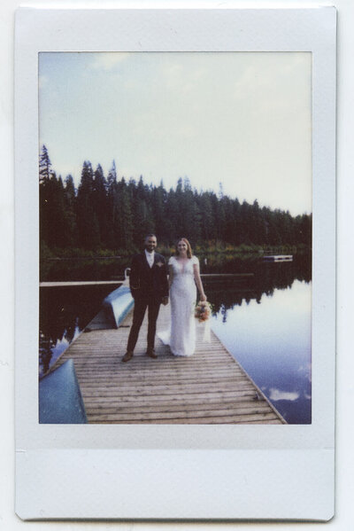 Scanned polaroid of a bride and groom on a dock at Suttle Lake Lodge, representing one photography medium used by Oregon wedding photographer Among the Oaks. 