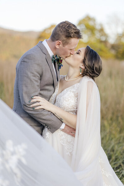 Portrait of groom kissing bride