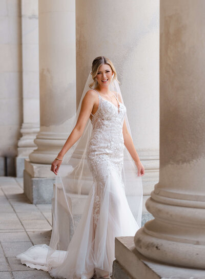 full length portrait of a bride holding out her veil taken by Ottawa wedding photographer JEMMAN Photography