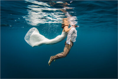 bride and groom underwater