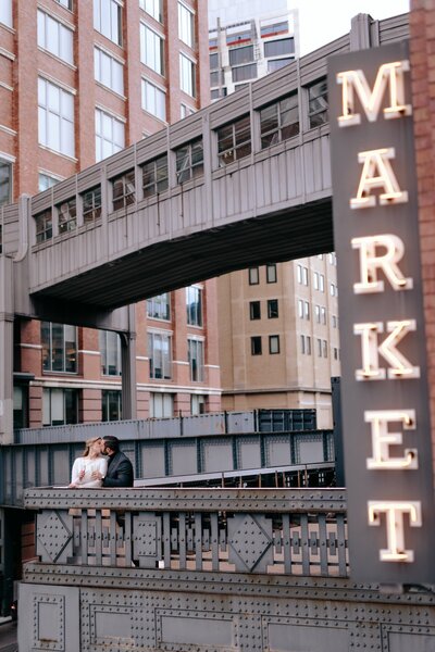 Photo of a couple kissing after their wedding in the middle of a street.