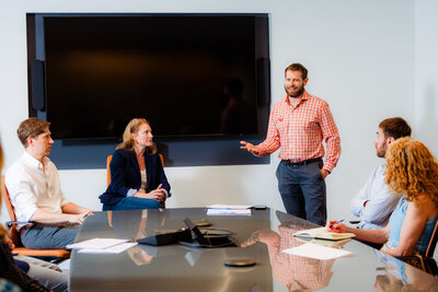 A person standing up and talking during a meeting