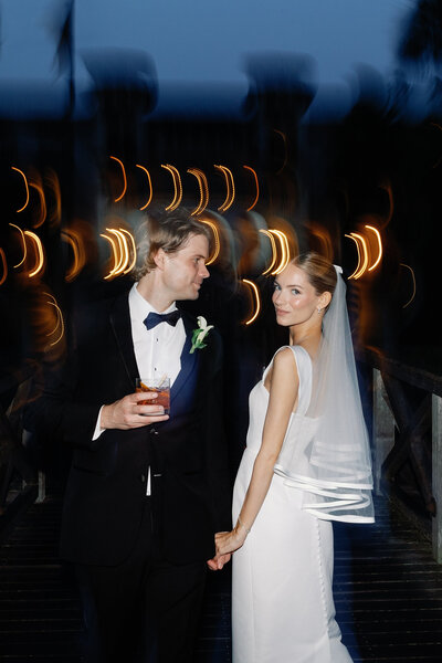 Bride wearing crown draped in an orange veil.