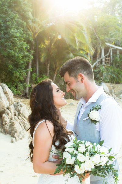 Bride and Groom smiling at each other on beach at Las Caletas in Puerto Vallarta Mexico Destination Wedding