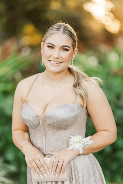 Senior highschool student dressed in formal gown for her formal celebration.