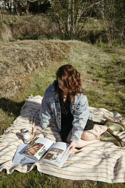 Isobel sitting in a meadow