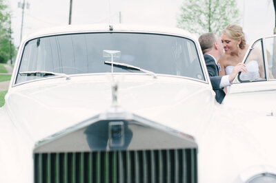 bride and groom getting in rolls-royce