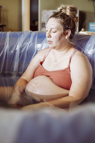 Tifton, GA birth photography: Woman labors calmly and serenely in birthing pool