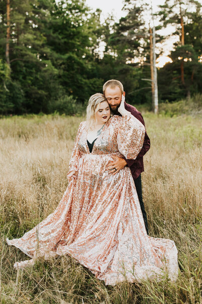 man hugging woman in grass field