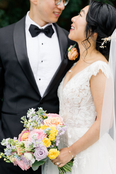 Wedding Photographer in Newport, RI, CT, and beyond | The Corteses | Bride with bridesmaid walking with the flowers.