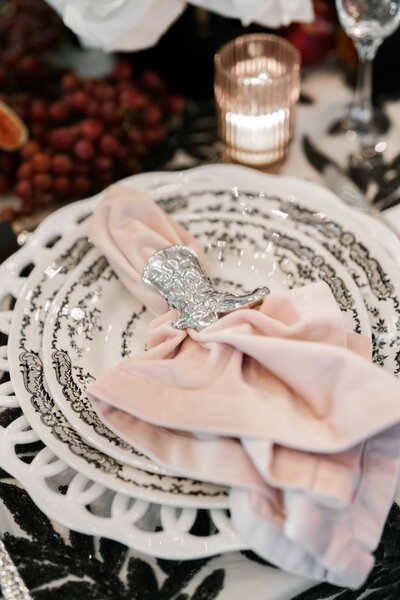 A place setting with a boot napkin holder
