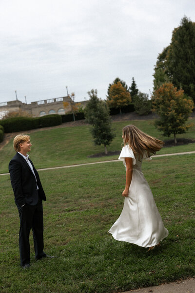 Couple captured in a romantic moment outdoors, surrounded by nature’s beauty, showcasing their love against a serene landscape.