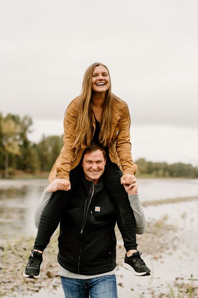 woman sits on man's shoulders