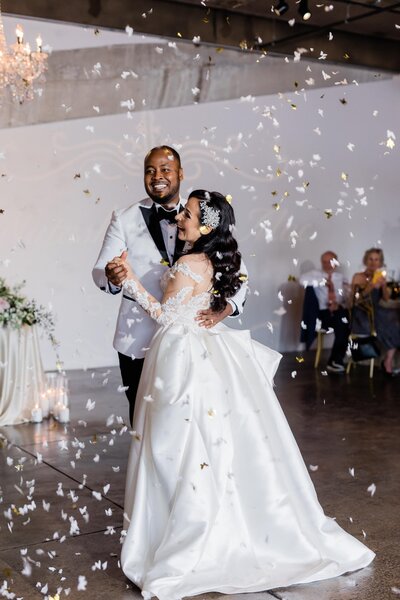 bride and groom first dance with confetti