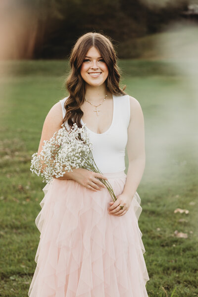 Family posed and smiling with buildings in the backgrou