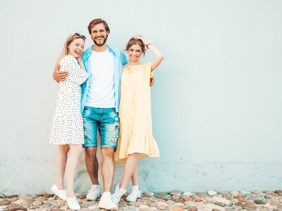 group-young-three-stylish-friends-posing-street-fashion-man-two-cute-girls-dressed-casual-summer-clothes-smiling-models-having-fun-near-wall-cheerful-women-guy-outdoors
