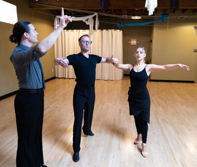 Couple learning ballroom dancing from their instructor at Dancers Studio.