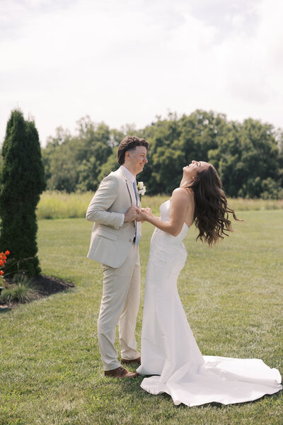 Wedding couple in the field near forest wedding venue in PA.