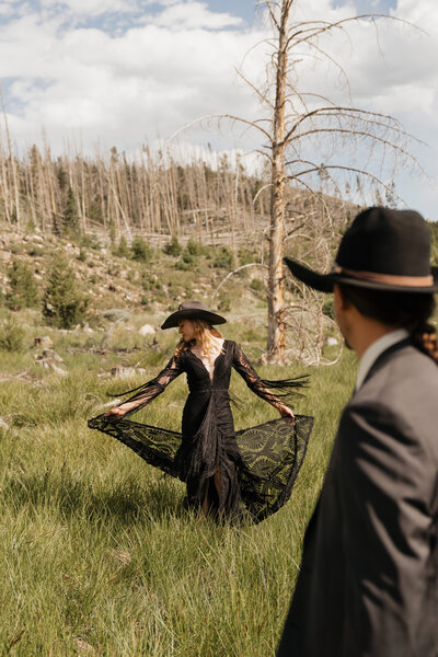 a bride twirling her dress while groom admires her
