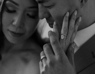 Bride puts her hand on groom's face
