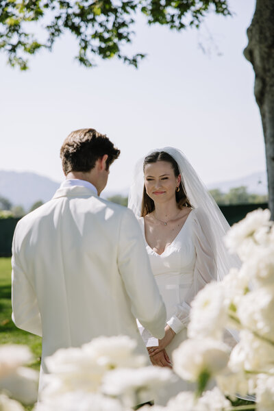 Payton looking at Evan while he reads his vows to her.