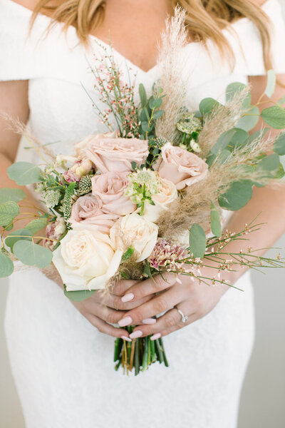 pink & white bridal bouquet in hands of bride