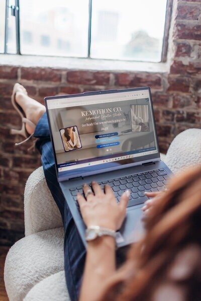 Kemotion business owner at her computer, working on a website launch for service-based businesses.