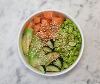 Glass jars filled with rice, vegetables, fruit, granola and more.