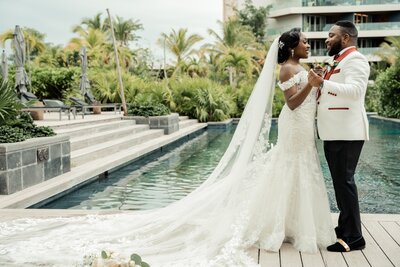 Nigerian wedding couple  embraces in front of pool