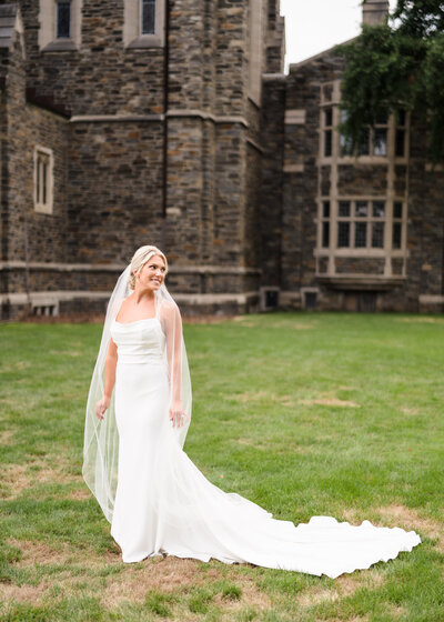 A bride poses in the lawn outside of First Congregational Church in Columbus