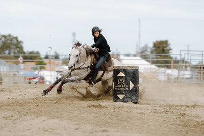 a barrel racer with a grey horse