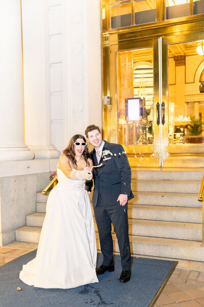 Bride and groom so cool while popping their wine