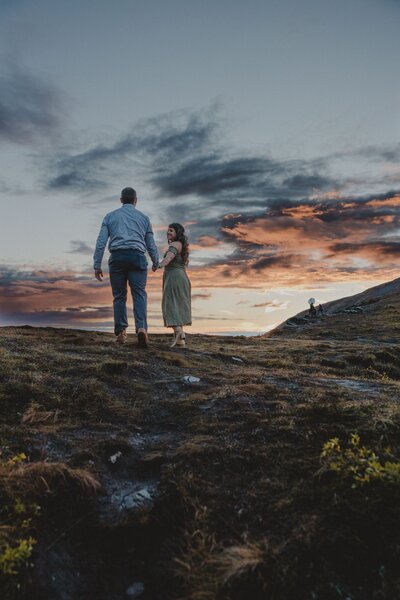 A Texas couple walks towards the sunset in Hatcher Pass, Palmer, Alaska