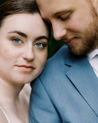 close up image by st paul wedding photographer tom thornton photography of couple with bride facing camera and groom eyes closed 