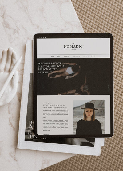 Flatlay of a table holding an iPad, which features a website mockup