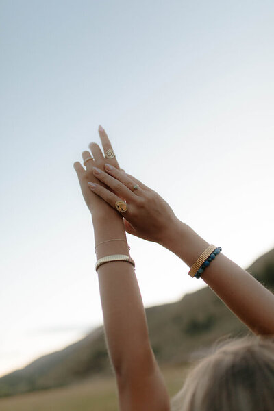 Candid senior portraits in Idaho Falls, Idaho. Close up of a girls hands in the air.