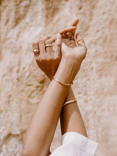 "Feminine hands lifted toward the light – image of surrender, self-trust, and nervous system support