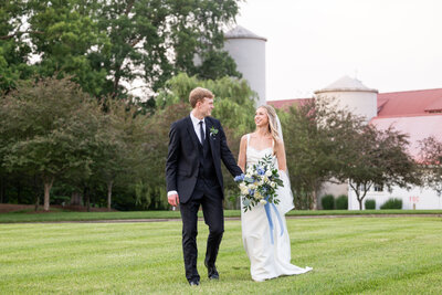 Spring wedding at WinMock at Kinderton, planned and designed by Charming Carolina — Elaina and Blake smiling together outside the venue on their wedding day.