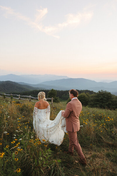 bride and groom standing on top of a mountain