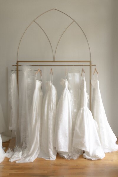 Row of wedding dresses hanging on a rack