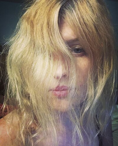 Blonde woman with hair in face