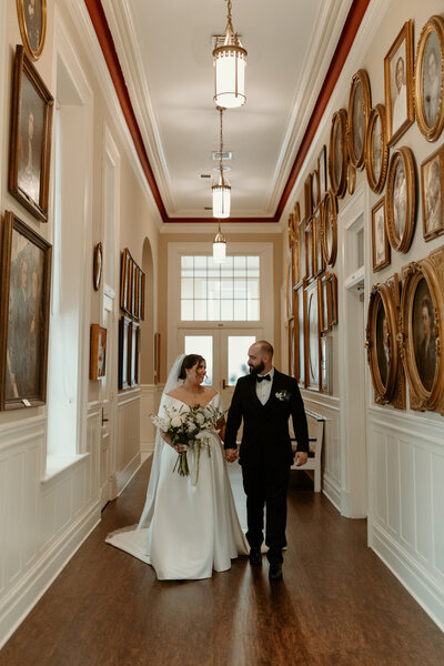 Black and white photo of bride and groom under the bride's veil on Mackinac Island
