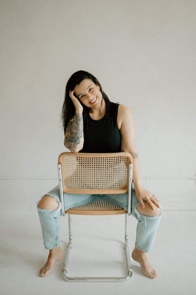 woman sitting on the chair backwards