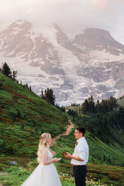 An eloping couple saying their wedding vows in front of Mount Rainier