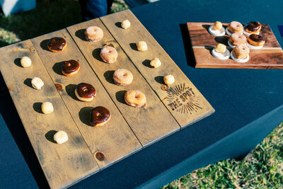 Custom wood board displaying mini donuts with “The Spot” branding, photographed by Joseph Mayden for use in brand marketing, product promotion, and social media content.