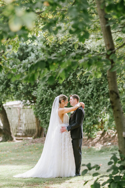 a married couple kisses on their wedding day outside of Bonnet Island Estate 