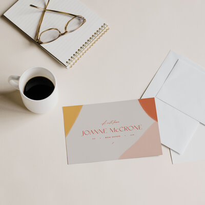 Joanne McCrone branded stationery with coffee and notebook, personalized real estate service with attention to detail.