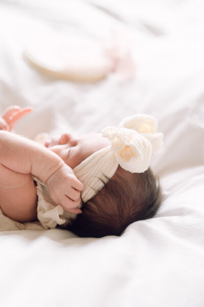 Peaceful newborn baby sleeping in natural light, photographed by a Northern Virginia family photographer during an in-home newborn session.