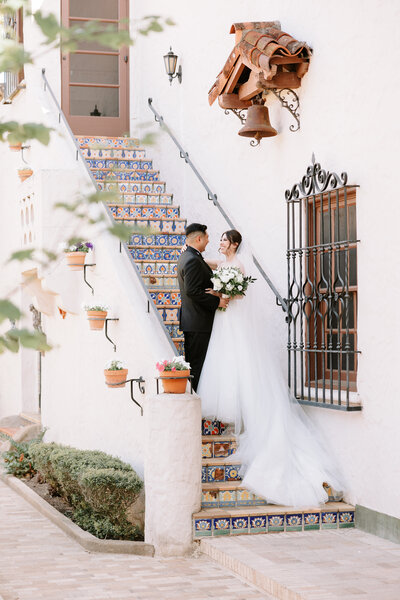 Photo of bride and groom together on steps at the mcnay courtyard in San Antonio