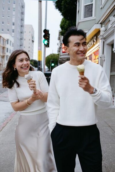 A couple eating ice cream during their engagement photo session in San Francisco